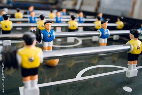 Close up on players of Table football soccer kicker foosball top-table game playing photo