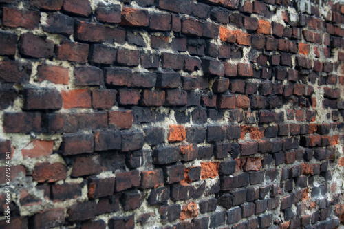 Dark brown brick building wall in Krakow old town, Poland