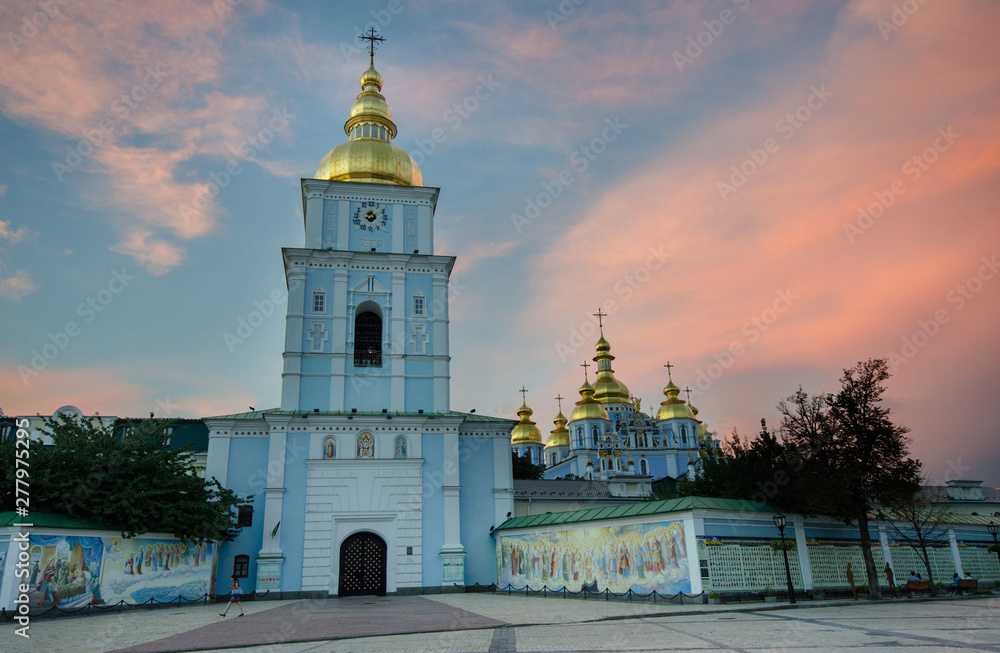 St. Michael's Golden-Domed Monastery with religious paintings on the outer walls just after sunset, Kiev, Ukraine