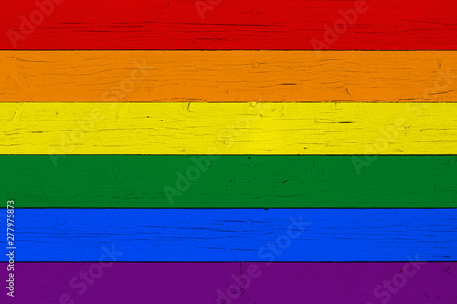 Rainbow flag on wooden background