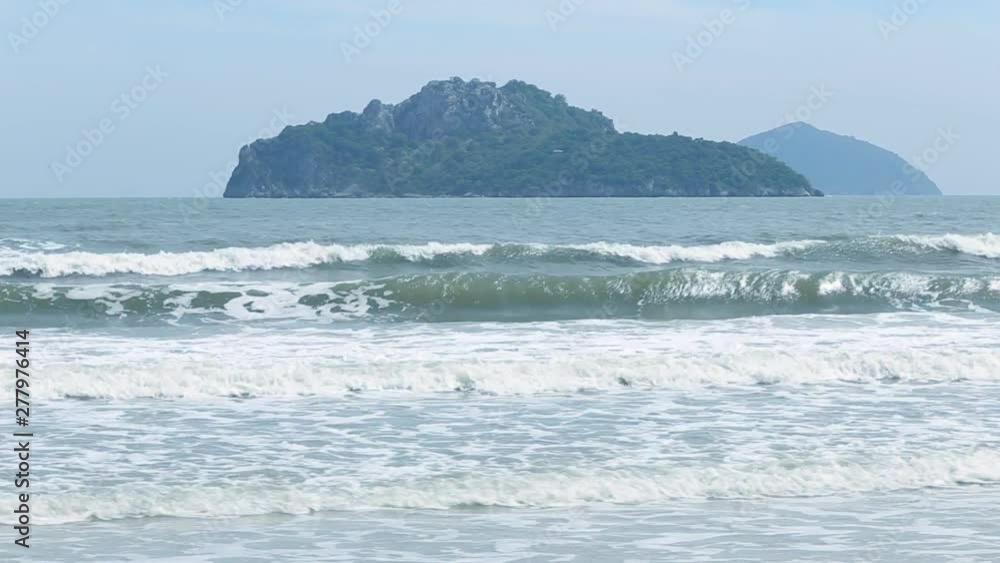 Narrow beach line,Sea waves with wave crashing on sandy shore Narrow beach line,Sea waves with wave crashing on sandy shore