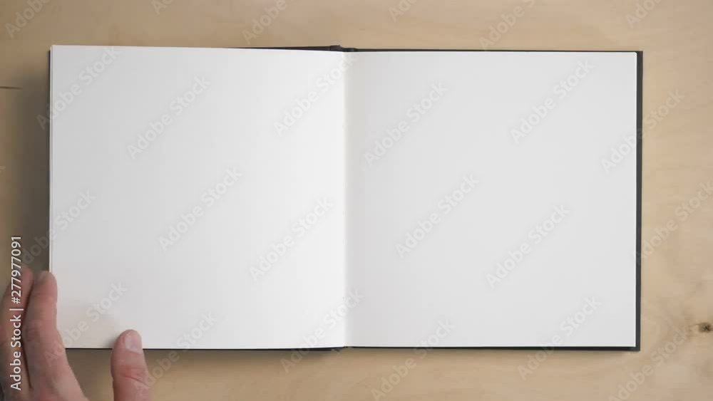 Notebook Flipped Open Opening a notebook. Blank pages to insert text and subtitles. The male ...