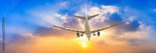 Airplane in the sky at sunrise