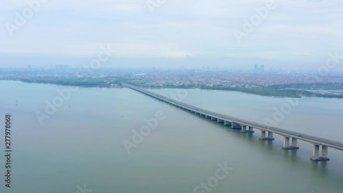 Wallpaper Mural Aerial view of Suramadu bridge with Madura strait background and Surabaya city on misty morning. Shot in 4k resolution from a drone flying forwards Torontodigital.ca