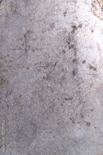 Background texture of old painted gray surface with scratches and stains. Close-up, vertical, top view, no people, free space. Concept of design.