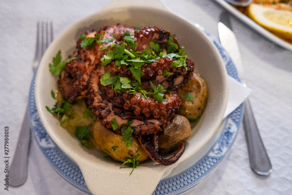 Entire Octopus Stewed in Red Wine and Served on a Bed of Small Boiled Potatoes Entire Octopus Stewed in Red Wine and Served on a Bed of Small Boiled Potatoes