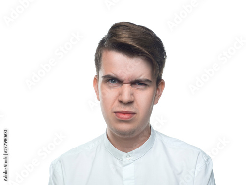 Portrait of a young man. Disgust. Bad smell. Isolated on white background