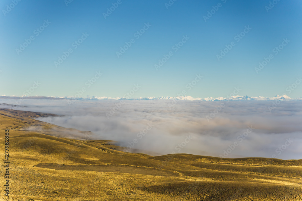 Amazing view of sea of fog and cloud above the golden yellow dried glass hill in autumn south Patagonia, Chile and Argentina, most iconic beautiful tourism place