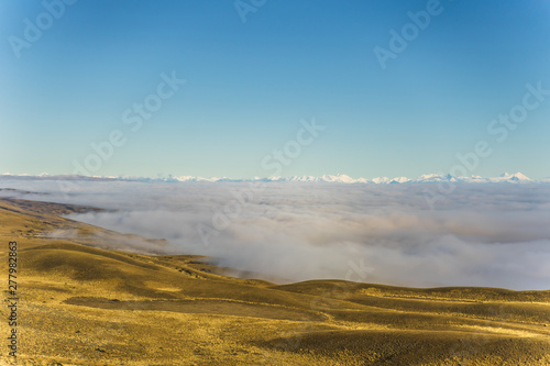 Amazing view of sea of fog and cloud above the golden yellow dried glass hill in autumn south Patagonia, Chile and Argentina, most iconic beautiful tourism place