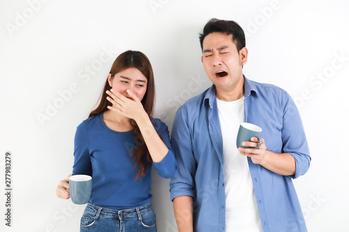 Asian couple in blue shirt on white background with cup of coffee happy and smile mood