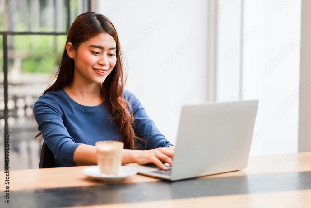 Asian business girl working and drinking coffee in cafe Asian business girl working and drinking coffee in cafe