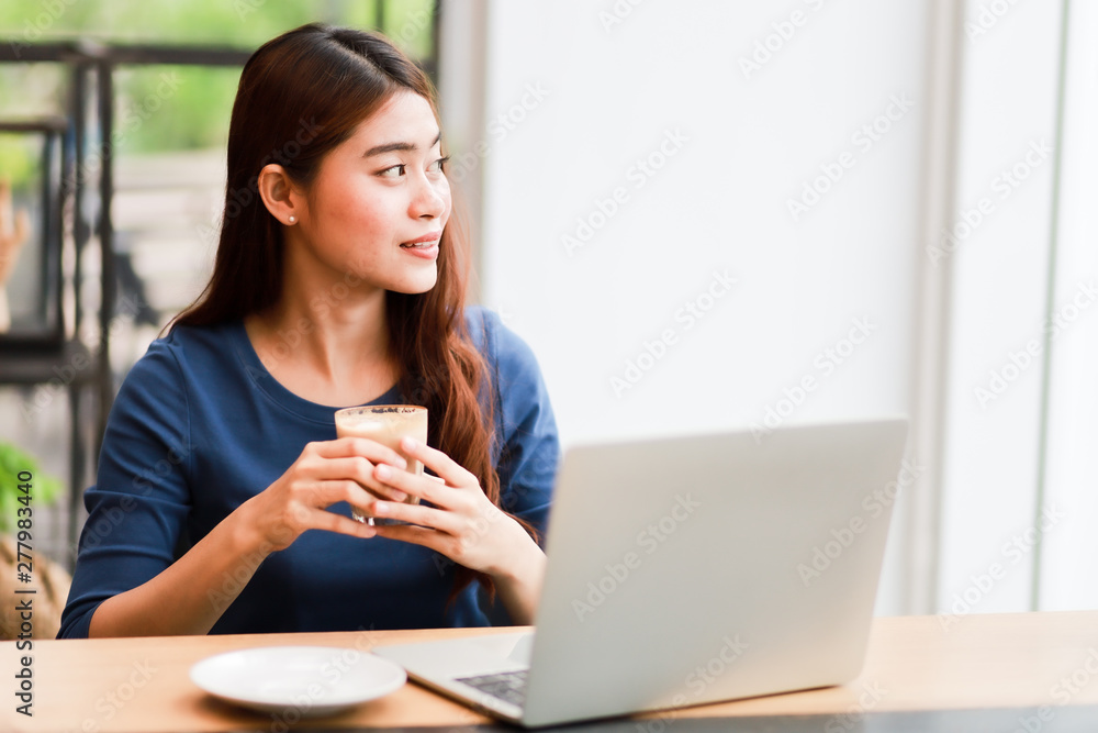 Asian business girl working and drinking coffee in cafe Asian business girl working and drinking coffee in cafe