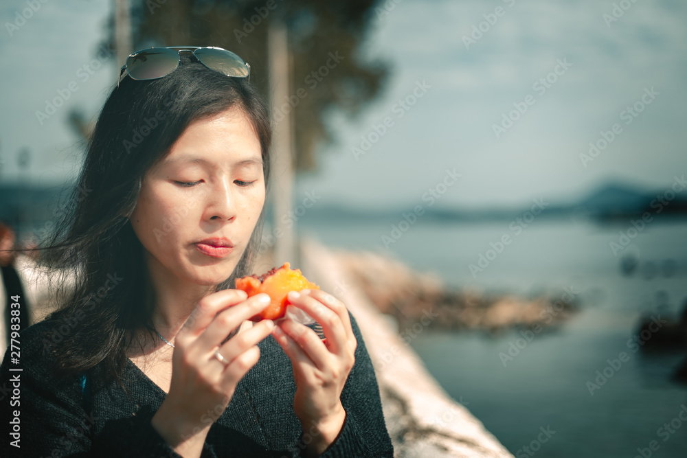 Woman eating traditional chinese sweet sticky rice cake