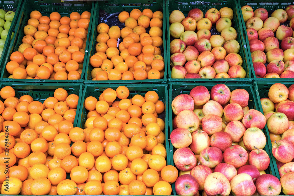 Oranges, tangerines and apples for sale at a market Oranges, tangerines and apples for sale at a market