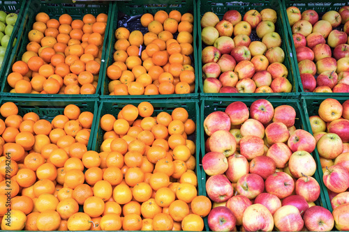 Oranges, tangerines and apples for sale at a market