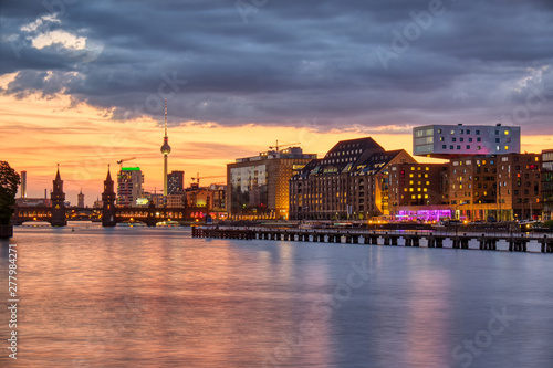 Dramatic sunset at the river Spree in Berlin with the famous Television Tower in the back