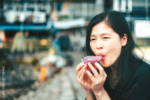 Woman eating traditional chinese sweet sticky rice cake