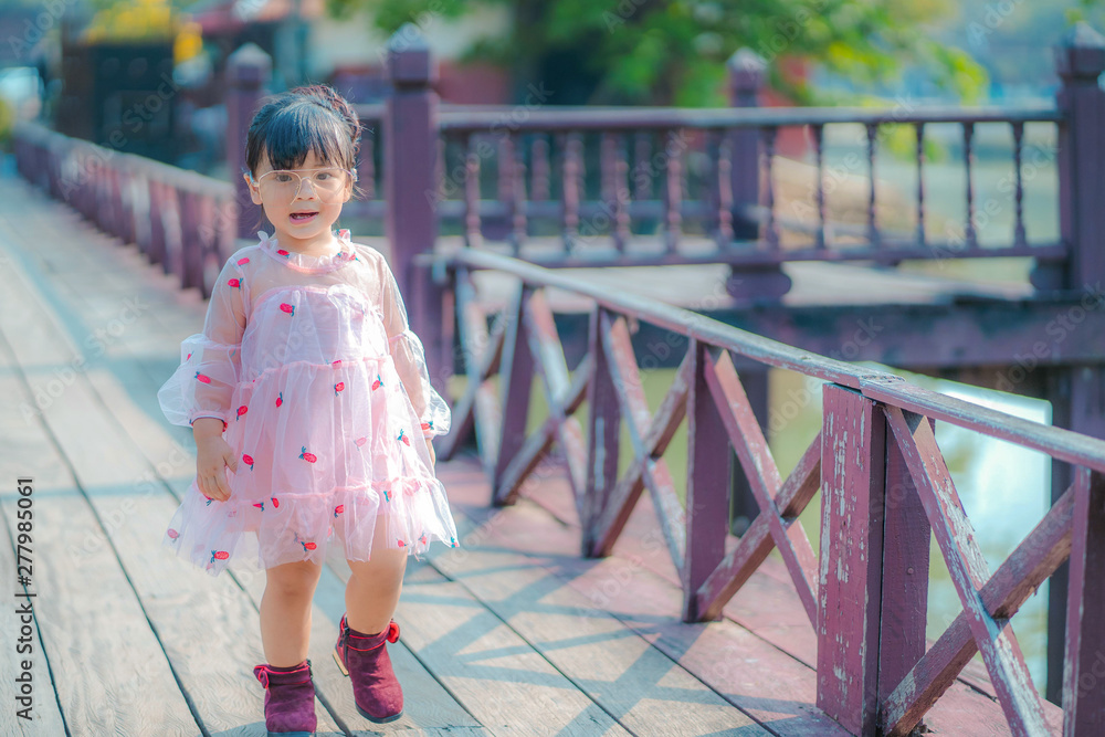 Naklejka premium portrait of a girl. Happy little girl in autumn park. Fashion Kid outdoor.