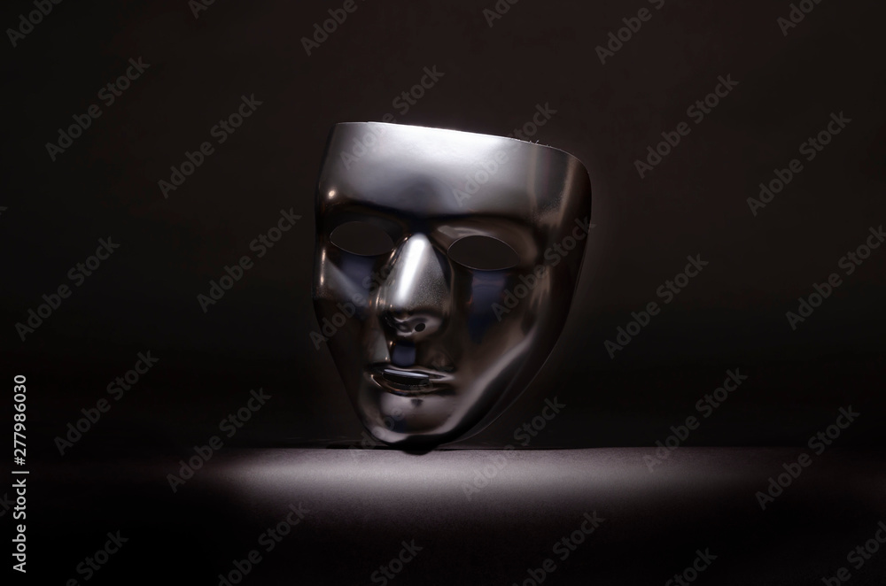 levitating chrome mask on black Stock Photo | Adobe Stock