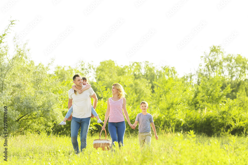 Happy family walking in park on summer day Happy family walking in park on summer day