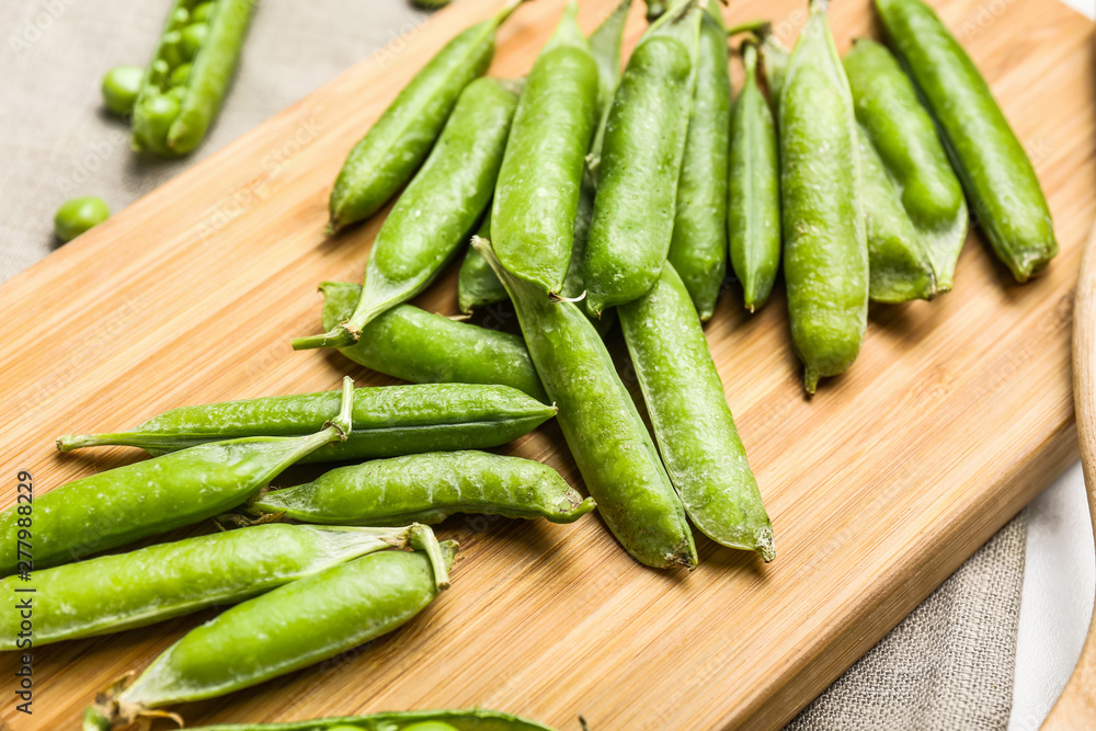 Tasty fresh peas on wooden board, closeup Tasty fresh peas on wooden board, closeup