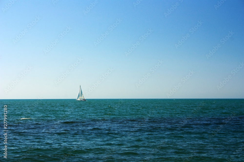 Lonely sail to the sea on the horizon