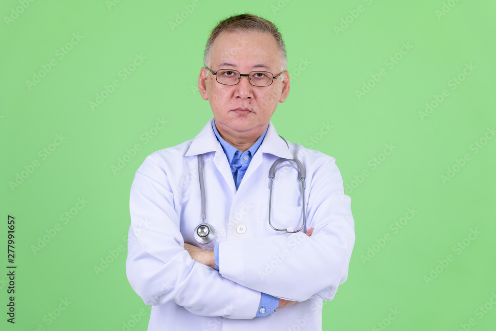 Mature Japanese man doctor with arms crossed Mature Japanese man doctor with arms crossed