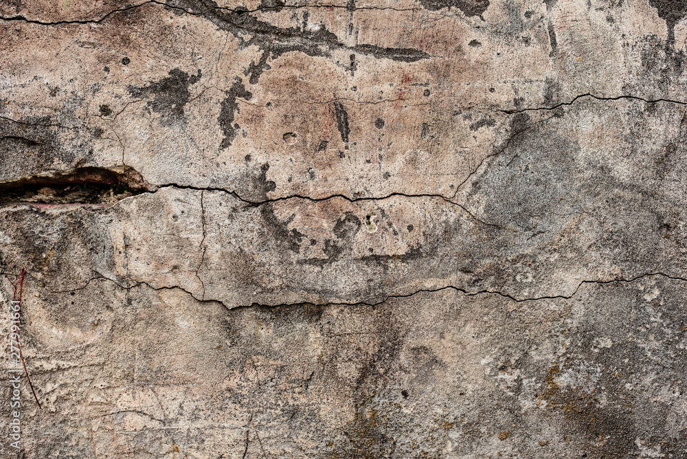 Texture of a concrete wall with cracks and scratches which can be used as a background Texture of a concrete wall with cracks and scratches which can be used as a background