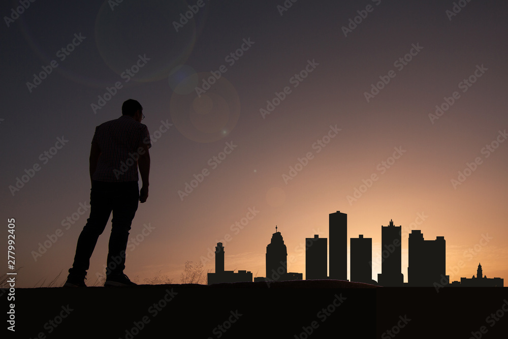 Traveler in front of Detroit city skyline
