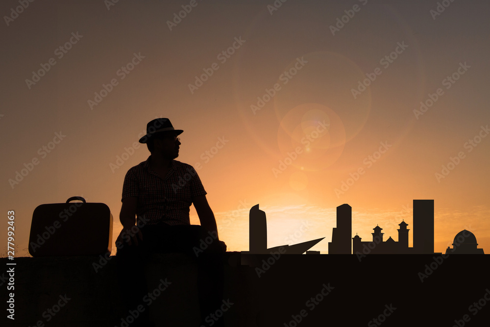 traveler in front of denver city skyline