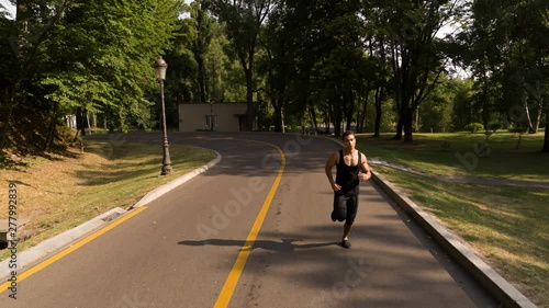 Wallpaper Mural Man running in Park sunny day Follow shot video. Sportsman Runner Athlete training  Torontodigital.ca