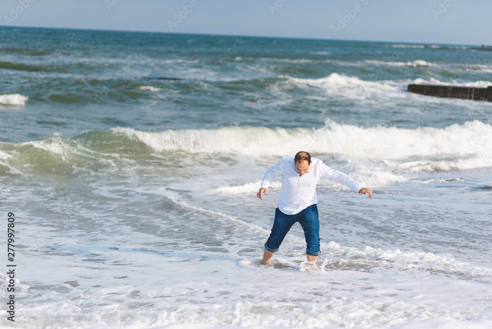 man having fun in sea waves