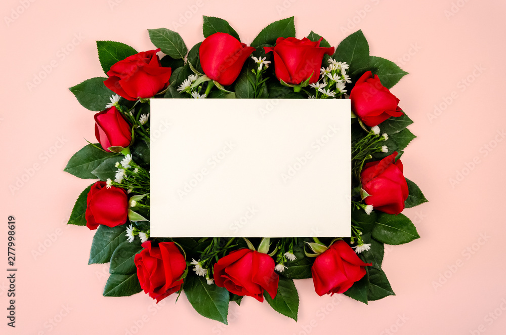 Red roses bouquet with blank white paper card on pastel pink background. Red roses bouquet with blank white paper card on pastel pink background.