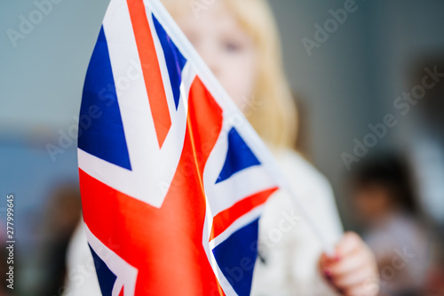 Little girl with flag of United Kingdom. Learn English. Schoolgirl, study abroad, international language courses. Flag of Great Britain.
