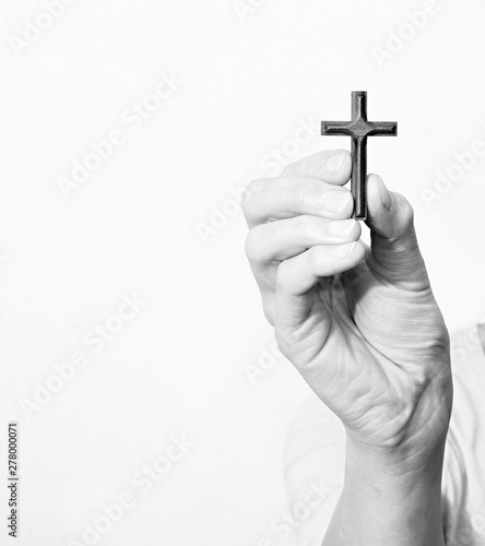 hand holding a cross stock image on white background stock photo