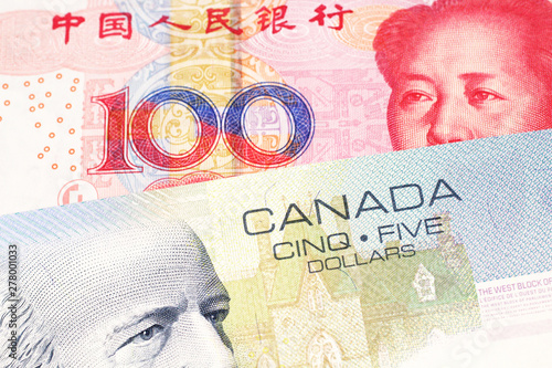 Photography A close up macro shot of a blue five Canadian dollar bill with a one hundred yua