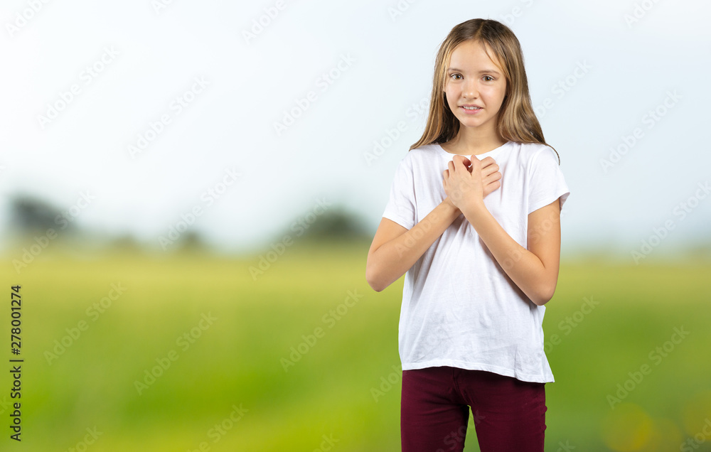 girl smiling with hands on chest with closed eyes and grateful gesture on face. Health concept girl smiling with hands on chest with closed eyes and grateful gesture on face. Health concept