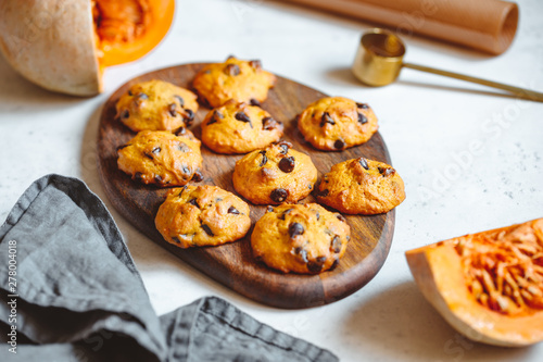Pumpkin cookies with chocolate chips made from cake mix on a wooden tray.