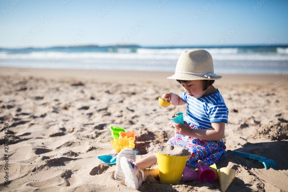 toddler girl plaiying at summer sand beach,Northern Ireland toddler girl plaiying at summer sand beach,Northern Ireland