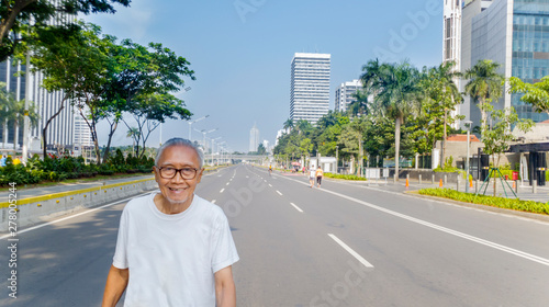 Elderly man exercising in car free day event photo