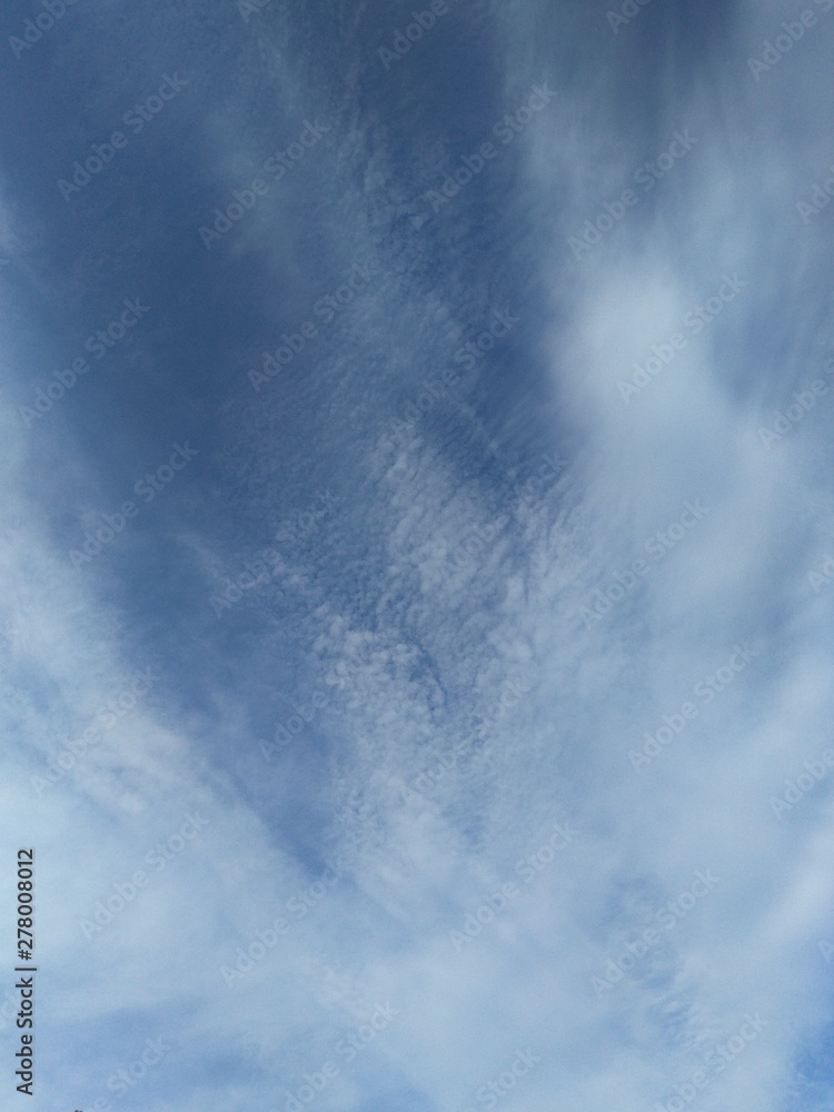 shaggy haze of white clouds smeared across blue sky, natural background
