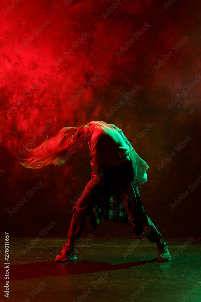 Photo of girl dancing modern dances on red-green background