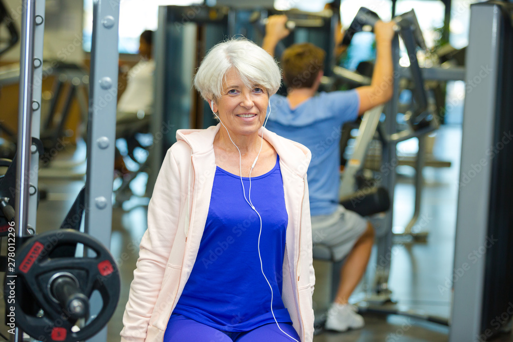 Fototapeta premium happy senior woman exercising at fitness center