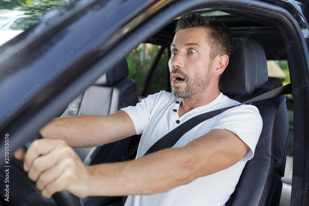 amazed stupefied bearded male inside of a car amazed stupefied bearded male inside of a car