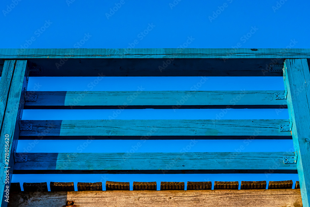 The span of the wooden railing of the pier against the sky The span of the wooden railing of the pier against the sky