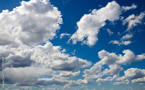 White clouds in the bright blue sky. The beauty of the nature