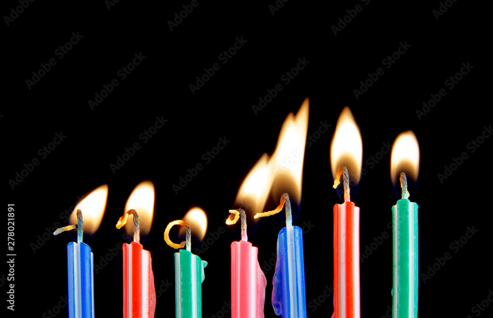 Burning candles on black background Burning candles on black background