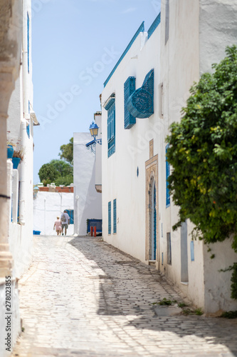 Sidi Bou Said, Tunisia - June.06, 2019: Alley with traditional white houses and blue doors.