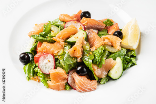 salad with smoked salmon on the white plate