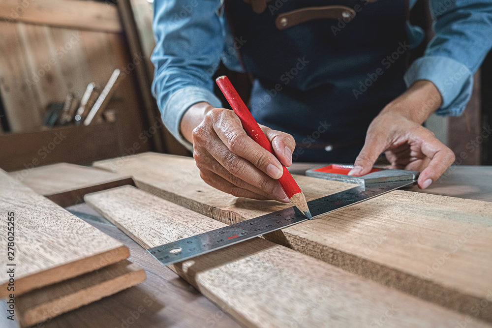 Carpenter working with equipment on wooden table in carpentry shop. woman works in a carpentry shop. Carpenter working with equipment on wooden table in carpentry shop. woman works in a carpentry shop.
